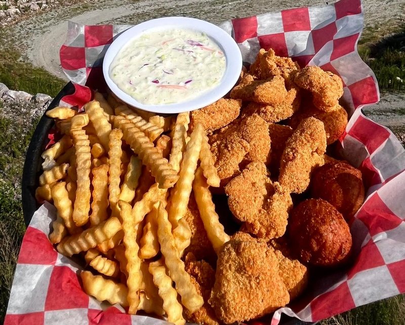Fried fish dinner with fries and coleslaw, overlooking the valley